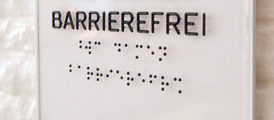Accessibility sign with braille